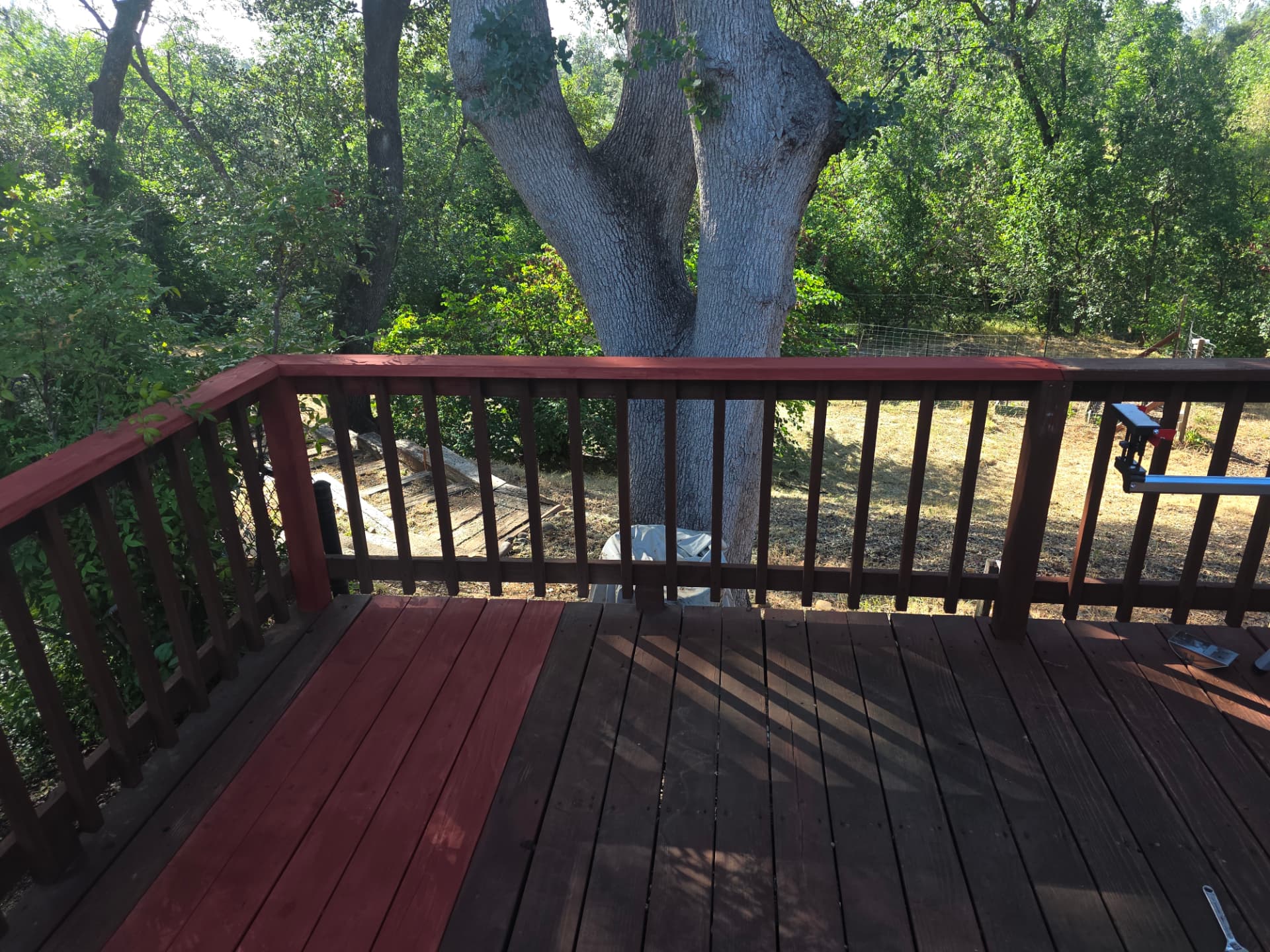 Cedar deck with rotted boards replaced and the damaged section rebuilt